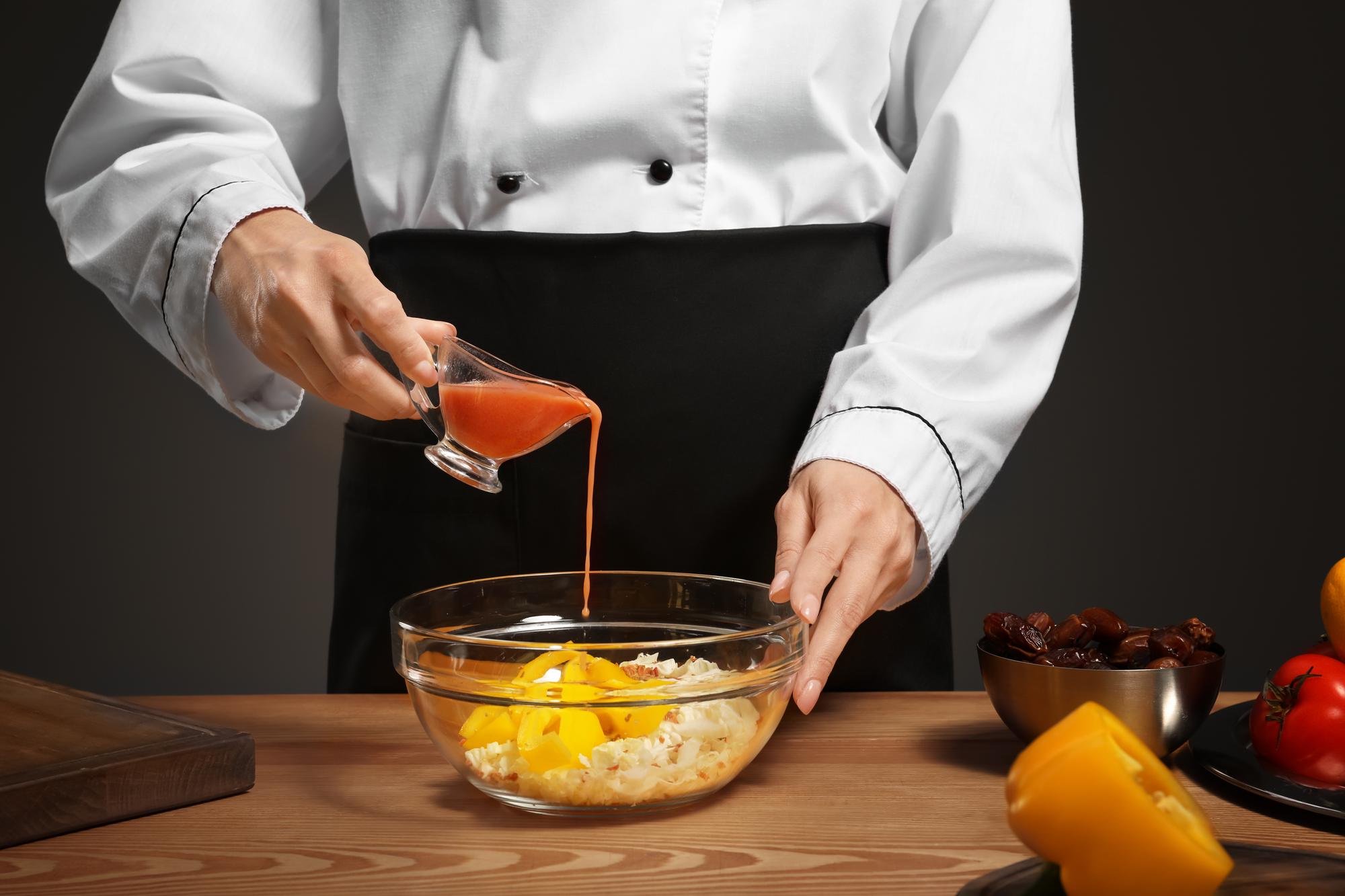 Head chef tasting sauce