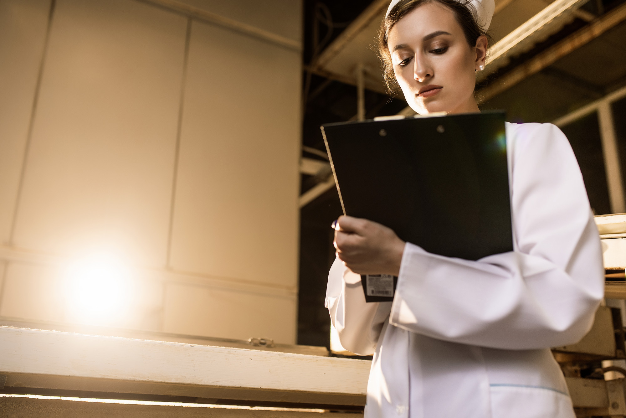 Consultant with clipboard in production